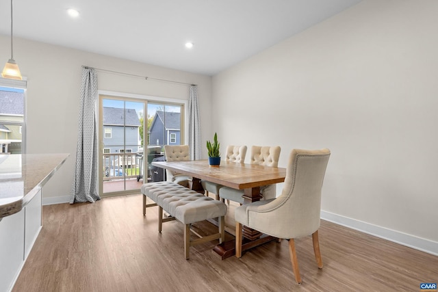 dining space featuring light wood-style flooring, baseboards, and recessed lighting