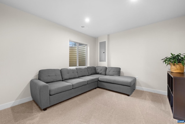 living room featuring baseboards, electric panel, visible vents, and light colored carpet