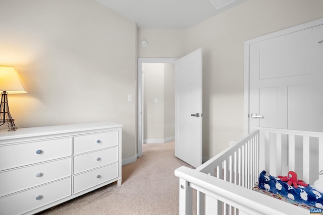 bedroom featuring baseboards and light colored carpet