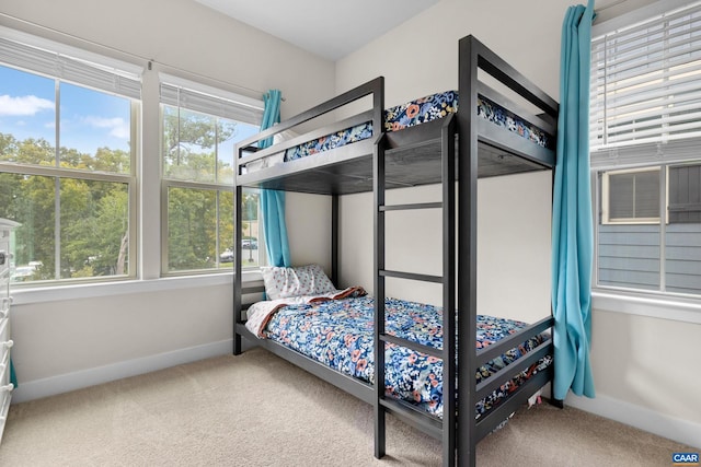 bedroom with carpet floors and baseboards