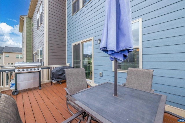 deck with outdoor dining area and area for grilling