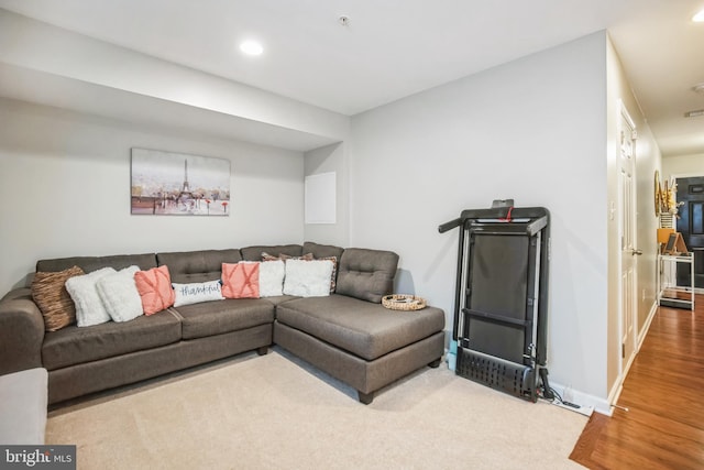 living room featuring recessed lighting, baseboards, and wood finished floors