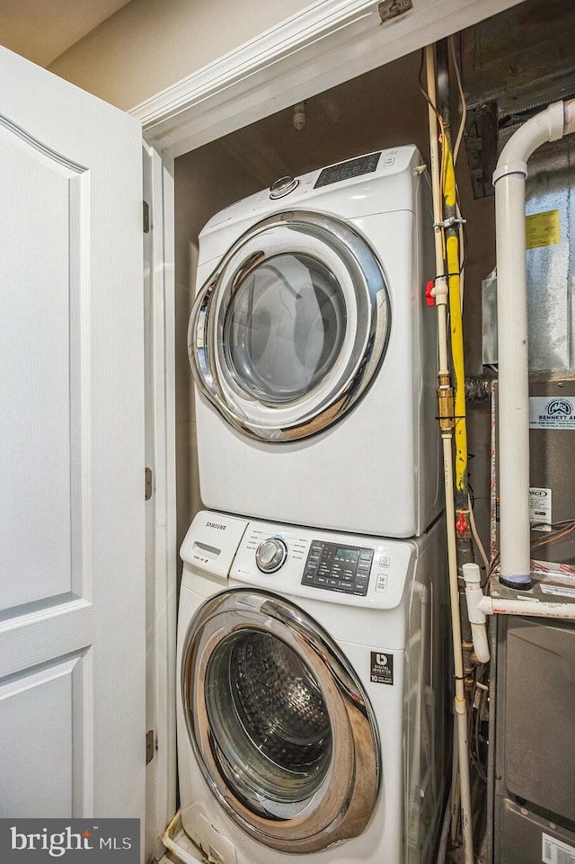 clothes washing area with laundry area and stacked washer / drying machine