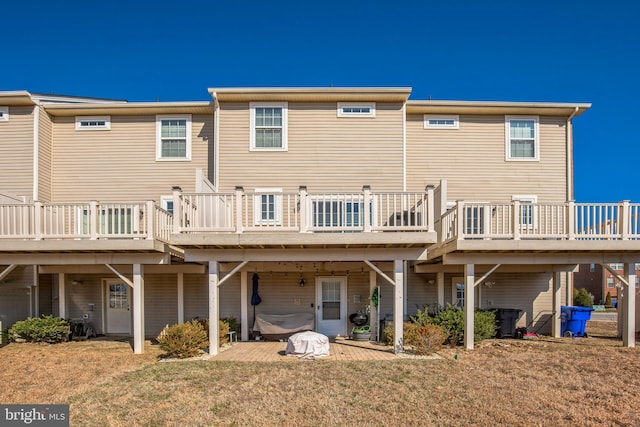 back of property with a patio area, a deck, and a yard