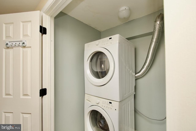 clothes washing area featuring laundry area and stacked washer and clothes dryer