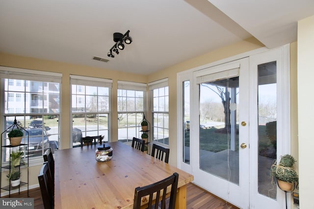 sunroom / solarium with french doors, visible vents, and a healthy amount of sunlight