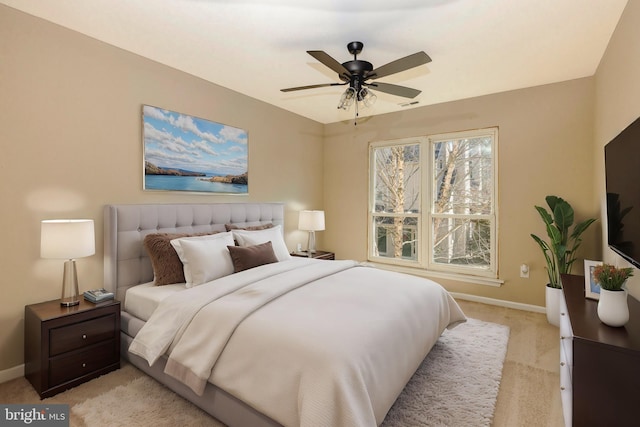 bedroom featuring light carpet and baseboards