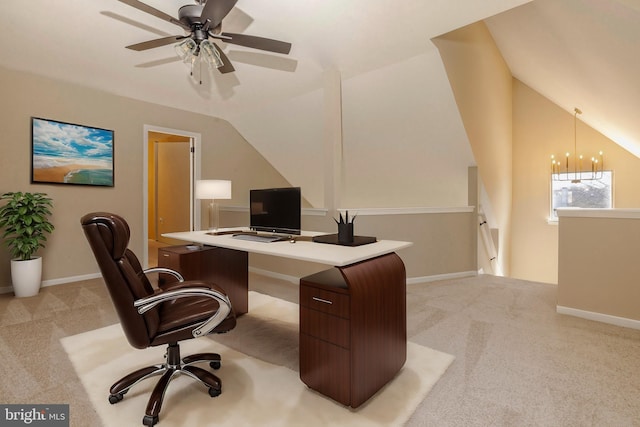 office space featuring baseboards, lofted ceiling, and light colored carpet