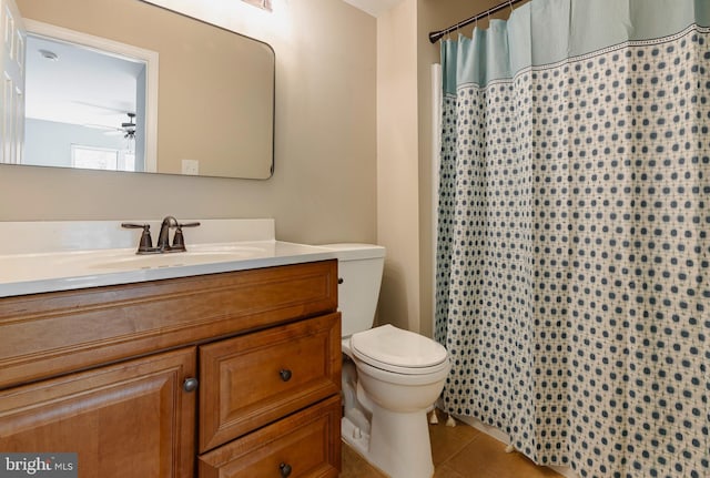 bathroom with ceiling fan, tile patterned flooring, toilet, vanity, and a shower with curtain