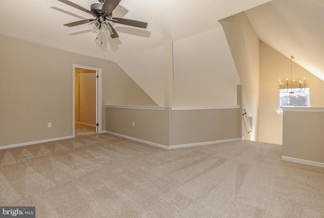 additional living space with vaulted ceiling, carpet floors, ceiling fan with notable chandelier, and baseboards