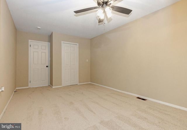 unfurnished bedroom featuring a closet, carpet flooring, visible vents, and baseboards