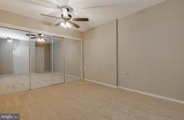 unfurnished bedroom featuring a ceiling fan, carpet flooring, and baseboards