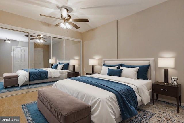 carpeted bedroom featuring a closet and a ceiling fan