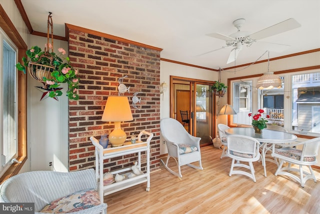 sunroom / solarium featuring a ceiling fan