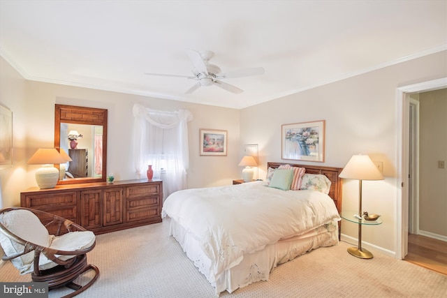 bedroom featuring light carpet, baseboards, ornamental molding, and ceiling fan