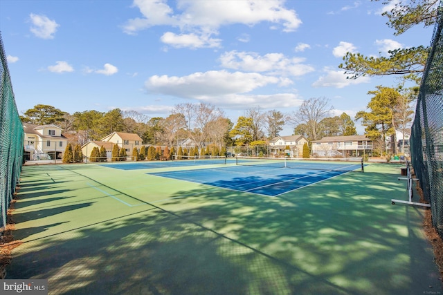 view of sport court featuring a residential view and fence