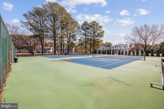 view of sport court featuring fence