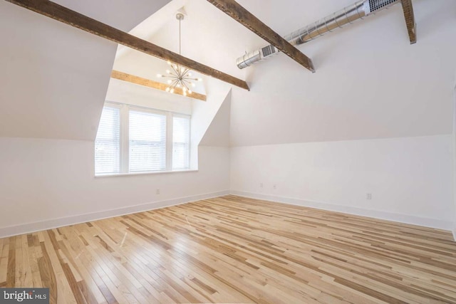 additional living space with vaulted ceiling with beams, wood-type flooring, a chandelier, and baseboards