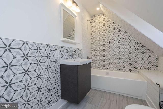 full bath with a bathtub, curtained shower, tile walls, and vanity