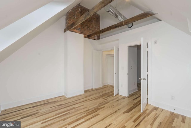 bonus room featuring baseboards and wood finished floors