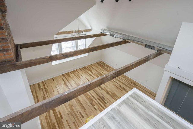 interior space featuring lofted ceiling and wood finished floors