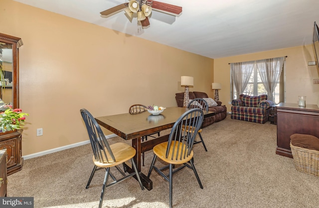 dining space featuring ceiling fan, carpet floors, and baseboards