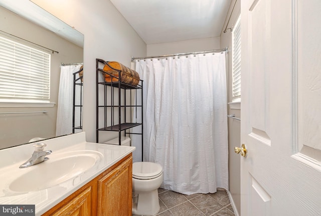 bathroom with tile patterned flooring, a shower with curtain, vanity, and toilet