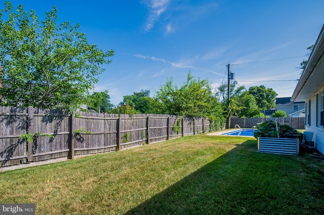 view of yard with a fenced in pool and a fenced backyard