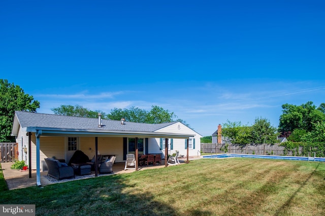 back of house with a patio area, a fenced backyard, an outdoor hangout area, and a fenced in pool