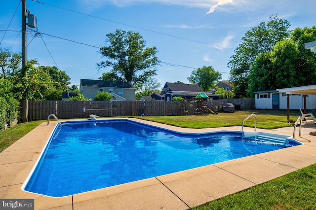 view of swimming pool featuring a fenced backyard, a playground, a fenced in pool, and a yard