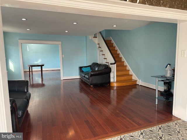 interior space with hardwood / wood-style flooring, baseboards, stairway, and recessed lighting