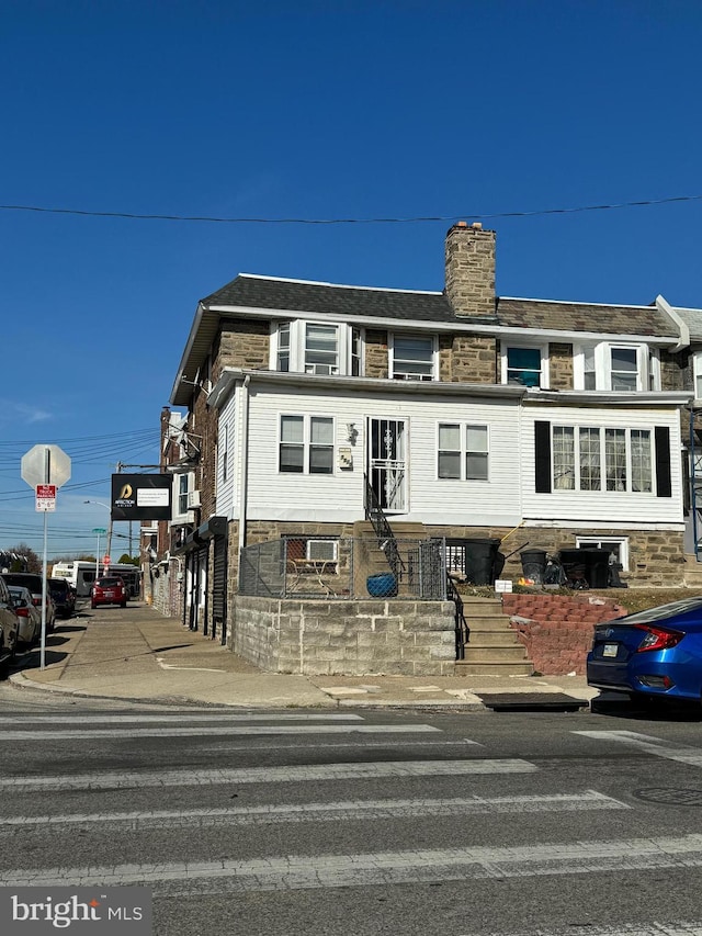 townhome / multi-family property featuring a chimney