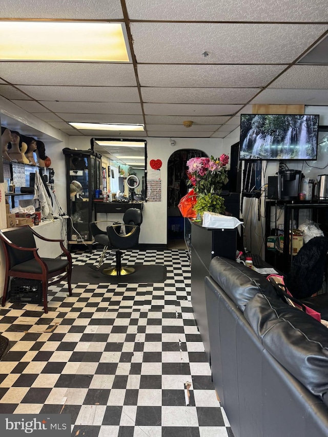 interior space featuring a paneled ceiling and tile patterned floors