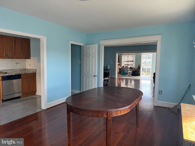 dining space with dark wood-style floors and baseboards