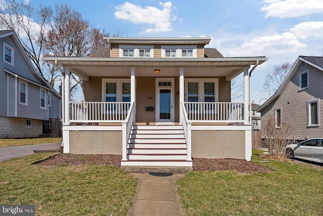 bungalow-style home with a porch and a front lawn