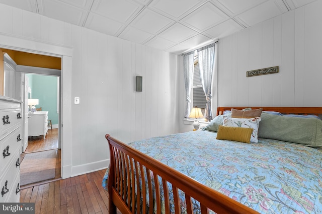 bedroom with an ornate ceiling, baseboards, and dark wood finished floors