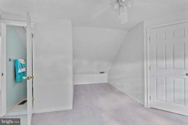 bonus room featuring carpet floors, lofted ceiling, ceiling fan, and baseboards