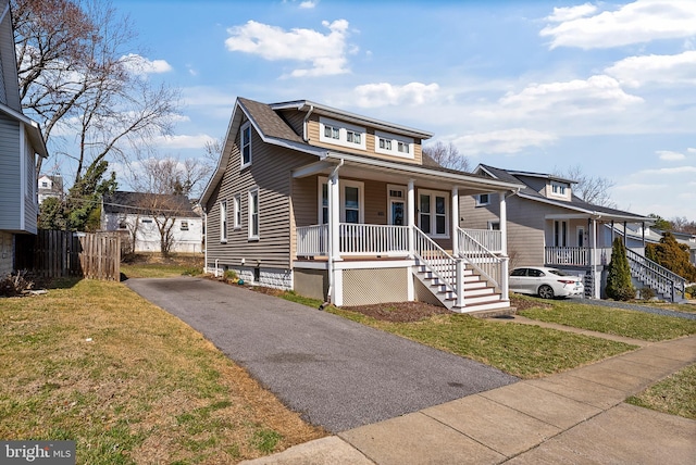 bungalow featuring a porch and a front yard