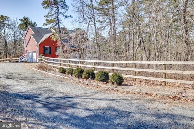 view of yard with a garage and fence