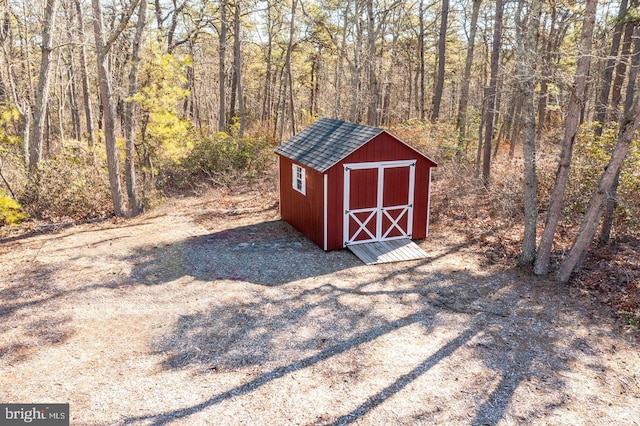 view of shed featuring a forest view