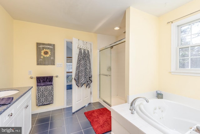 ensuite bathroom featuring tile patterned flooring, connected bathroom, vanity, a jetted tub, and a shower stall