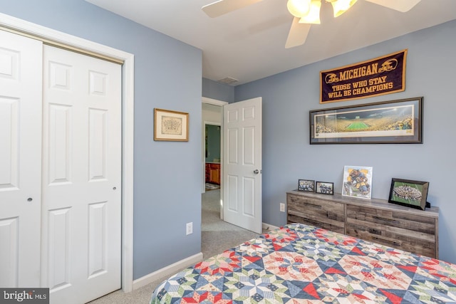 carpeted bedroom featuring a ceiling fan, a closet, and baseboards