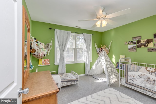 bedroom featuring ceiling fan, carpet floors, visible vents, and baseboards