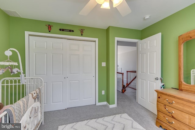 carpeted bedroom with ceiling fan, baseboards, and a closet