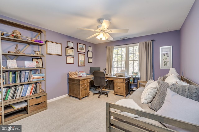 home office with light carpet, a ceiling fan, and baseboards