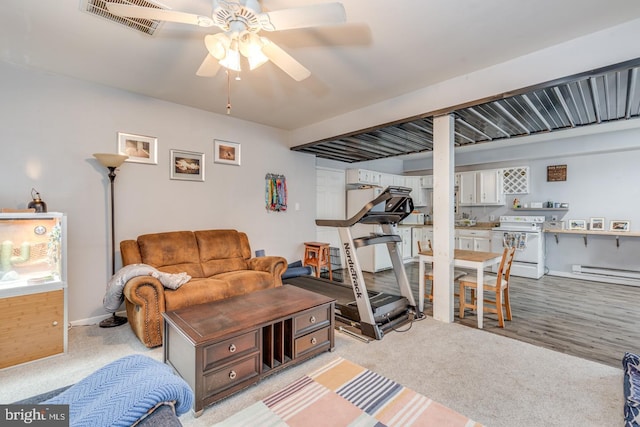 living area with ceiling fan, a baseboard radiator, light carpet, visible vents, and baseboards