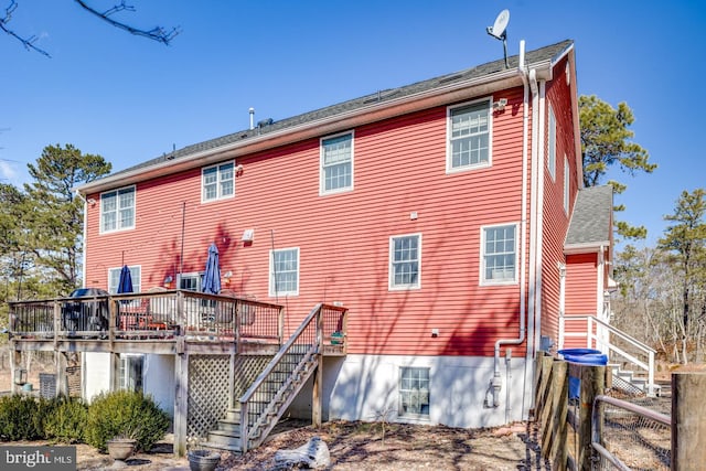 rear view of property with a deck and stairway