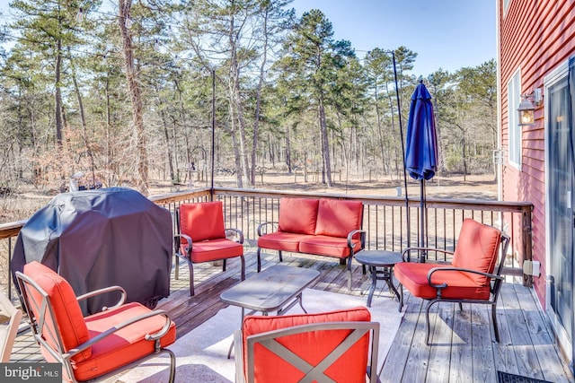 wooden terrace featuring outdoor lounge area and grilling area