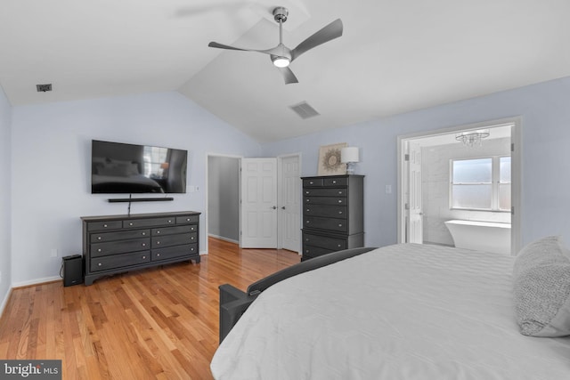 bedroom with lofted ceiling, light wood-style floors, baseboards, and visible vents