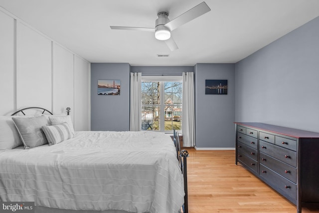 bedroom featuring visible vents, baseboards, a ceiling fan, and light wood finished floors